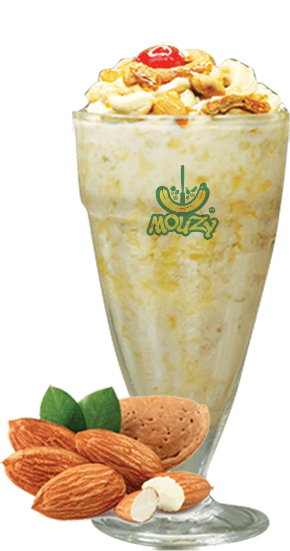 A tall glass of Mouzy banana Avil Milk crowned with dry fruits
